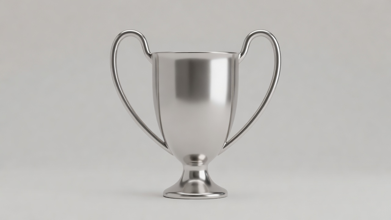 Silver trophy with large handles rendered in soft light against a plain backdrop